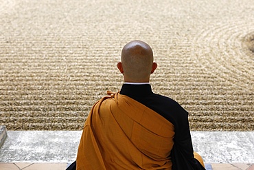 Zen Buddhist master practising Zazen (meditation) in Orval Trappist Abbey's Zen garden, Belgium, Europe