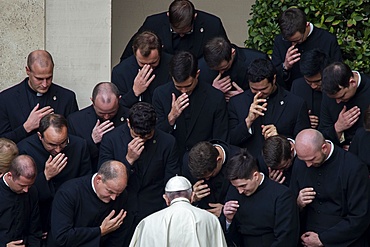 Pope Francis prays with priests at the end of a limited public audience at the San Damaso courtyard in The Vatican, Rome, Lazio, Italy, Europe