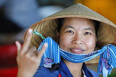 Woman with the traditional Vietnamese conical hat working in a fish factory, Vung Tau, Vietnam, Indochina, Southeast Asia, Asia