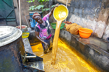 Villager making palm oil in Dokoue, Benin