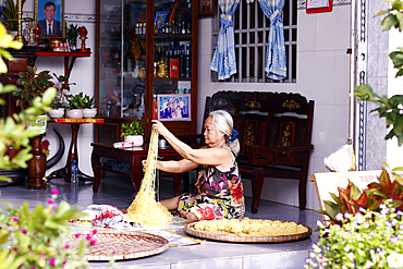 Senior woman making fresh noodles at home. An Giang Province. Mekong Delta, Vietnam.