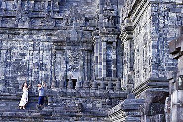 Prambanan 9th century Hindu temple. Visitors shooting pictures with smartphone. Java. Indonesia.