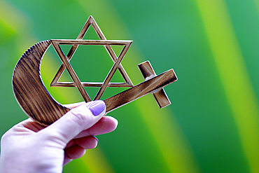 Religious symbols of interfaith dialogue concept, Jewish Star of David, Muslim Crescent, Christian Cross, Indonesia