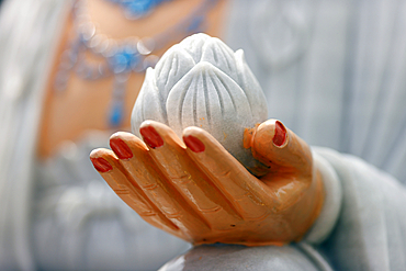 Cau dung Pagoda. Guan Yin, Guanyin, Quan Am, bodhisattva, goddess of compassion. Close up on hand. Lotus flower. An Giang Province. Mekong Delta, Vietnam.