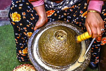 Woman making organ oil in the medina, Marrakesh, Morocco