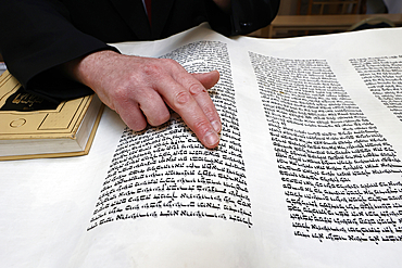 Celebration of Purim festival at Beth Loubavitch synagogue, Montrouge, France. Rabbi reading the meghilat, book of Esther