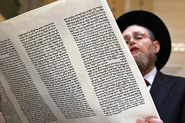 Celebration of Purim festival at Beth Loubavitch synagogue, Montrouge, France. Rabbi reading the meghilat, book of Esther