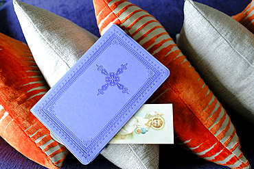 Pray at home. Bible with a religious image on a cushion.