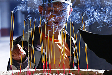 Tac Say Church, also known as Father Diep Church. Believer praying after lighting incense. Bac Lieu. Vietnam. .