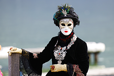 Woman wearing traditional mask and costume. Annual venetian carnival of Annecy, Haute Savoie, France.