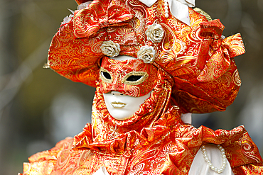 Woman wearing traditional mask and costume. Annual venetian carnival of Annecy, Haute Savoie, France.