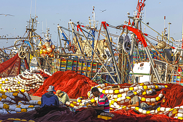 Fishing net mending in harbor, Essaouira, Morocco