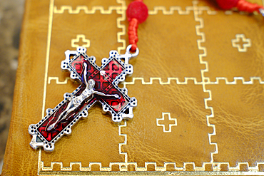 Old holy bible with a leather cover and a Rosary. Jesus on the cross. The crucifixion.