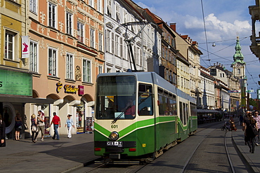 Tram on Herrengasse, with Stadtpfarrkirche (city parish church) in distance, Graz, Styria, Austria, Europe