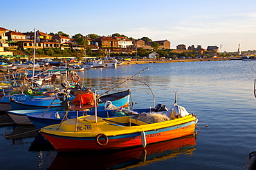 Fishing boats and view towards ramparts and ruins of the medieval fortification walls, Nessebar, Black Sea, Bulgaria, Europe