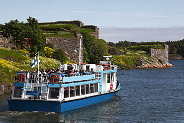 Ferry to Helsinki, with historic Fortress walls in the background, UNESCO World Heritage Site, Suomenlinna Island, Helsinki, Finland, Scandinavia, Europe