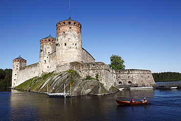 Girls relaxing beside Olavinlinna Medieval Castle (St. Olaf's Castle), Savonlinna, Saimaa Lake, Savonia, Finland, Scandinavia, Europe