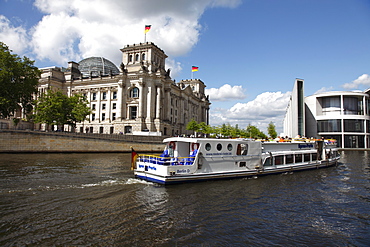 Tour boat on river cruise on the Spree River passing the Reichstag (Parliament), Berlin, Germany, Europe