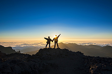 Tourists in backlight waiting for sunset, Haleakala National Park, Maui, Hawaii, United States of America, Pacific