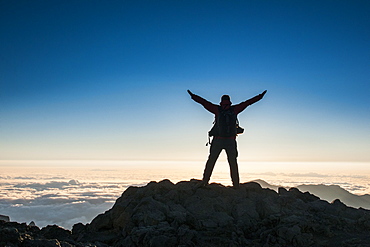 Tourist in backlight waiting for sunset on top of Haleakala National Park, Maui, Hawaii, United States of America, Pacific