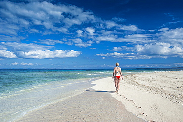 Woman walking along the white sand beach of Beachcomber Island, Mamanucas Islands, Fiji, South Pacific, Pacific