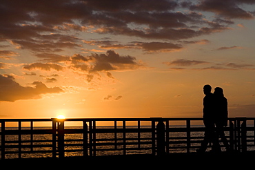 Couple walking along the pier of Playa de las Americas, Tenerife, Canary Islands, Spain, Atlantic, Europe