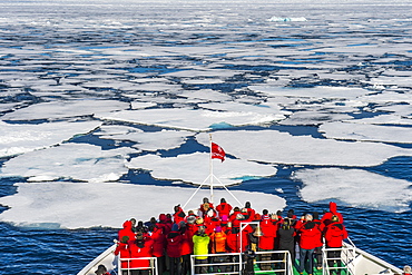 Expedition boat navigating through the pack ice in the Arctic shelf, Svalbard, Arctic