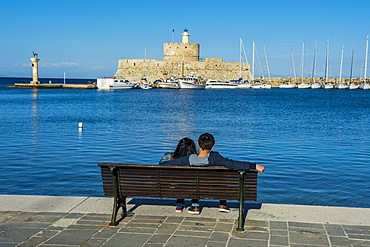 The old Agios Nikolaos fortress and lighthouse in Mandraki Harbour, Rhodes Town, Rhodes, Dodecanese Islands, Greek Islands, Greece, Europe