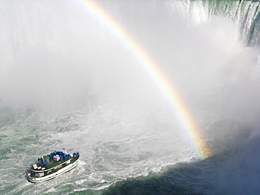 Maid of the Mist tour boat approaching the Canadian Falls with a rainbow, Niagara Falls, Ontario, Canada, North America