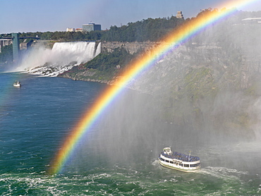 Maid of the Mist tour boat approaching the Canadian Falls with a rainbow, Niagara Falls, Ontario, Canada, North America