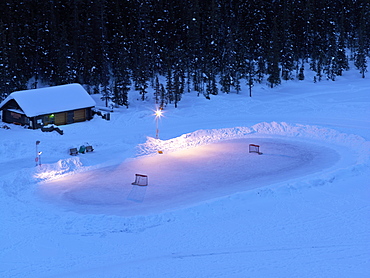 Ice hockey rink on frozen Lake Louise, Banff National Park, Alberta, Canada, North America