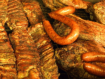 Ribs, and beef brisket grilling in an open pit BBQ grill in Texas BBQ style, Houston, Texas, United States of America, North America