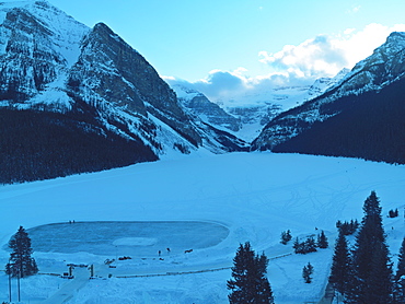 Dawn on Mount Victoria on Lake Louise with skating rink on frozen lake, Lake Louise, Banff National Park, UNESCO World Heritage Site, Alberta, Rockies, Canada, North America