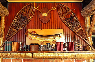 Snowshoes, fish, trophies and books decorating a rustic mantlepiece, Lake Placid, Adirondacks, New York State, United States of America, North America