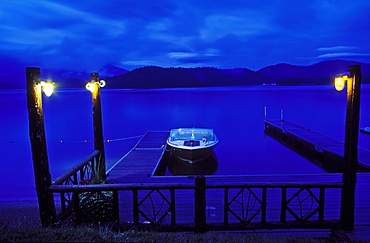 Boat moored at a dock at twilight, Lake Placid, New York State, United States of America, North America