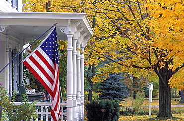 US flag on porch in autumn, Manchester, Vermont, New England, United States of America, North America