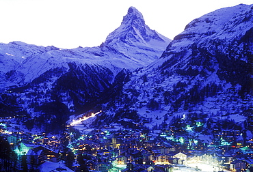 View of town in winter at dusk with the Matterhorn, Zermatt, Valais, Switzerland, Europe