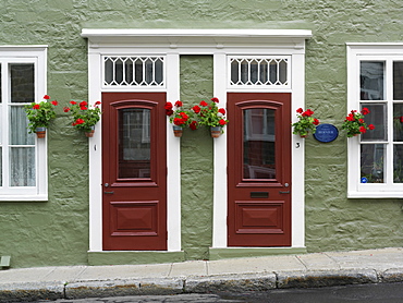 Facade of residences with doors and flowers in pots, Quebec City, Quebec, Canada, North America