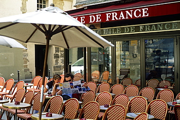 Couple reading a street map at an empty cafe, Paris, France, Europe