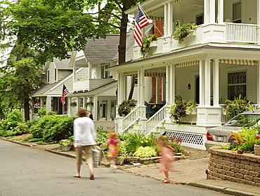 Mother walking on street with two young girls, Chautauqua, New York State, United States of America, North America