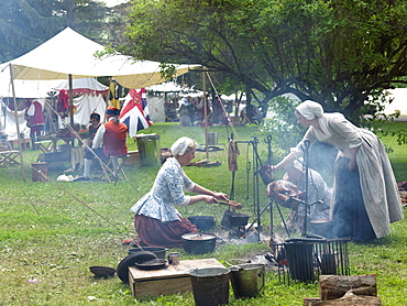 French-Indian War reenactment, women cooking a turkey over an open fire, Fort Niagara, Youngstown, New York State, United States of America, North America