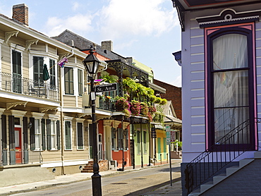 Colorful French Quarter residential street with wrought iron balconies and hanging flower baskets, New Orleans, Louisiana, United States of America, North America