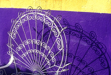 Chair casting a shadow on yellow and purple wall, Playa del Carmen, Quintana Roo, Yucatan, Mexico, North America