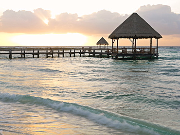 Pier with palapa jutting out into the water from the beach at sunrise, Mayan Riviera, Akumal, Yucatan, Quintana Roo, Mexico, North America