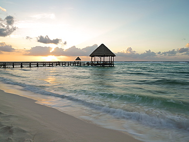 Pier with palapa jutting out into the water from the beach at sunrise, Mayan Riviera, Akumal, Yucatan, Quintana Roo, Mexico, North America