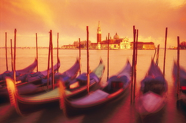 Gondolas moored at Molo San Marco at dusk, blurred with time exposure, church of San Giorgio Maggiore in background, Venice, UNESCO World Heritage Site, Veneto, Italy, Europe