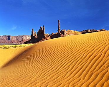 Totem Pole and Yei Bi Chei rock formations and sand dunes, Monument Valley, Arizona, United States of America, North America