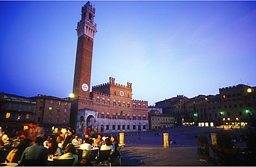 Torre del Mangia and Palazzo Pubblico at dusk, with people at cafe, Siena, UNESCO World Heritage Site, Tuscany, Italy, Europe