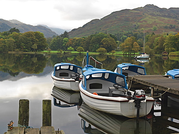 Boats moored at dock for rent on Ullswater, Glenridding, Ullswater, Lake District National Park, Cumbria, England, United Kingdom, Europe