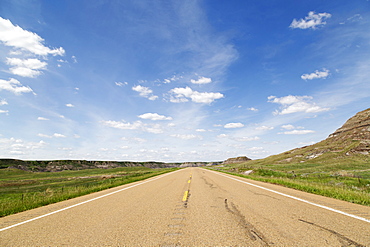 Blue sky over a highway through the Badlands of Alberta, near Drumheller, Alberta, Canada, North America